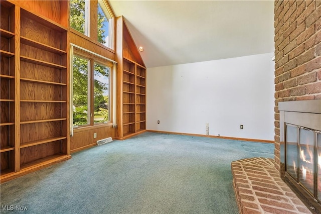 118 Steeplechase Ln, Munroe Falls, OH 44262 - unfurnished living room with vaulted ceiling, carpet floors, built in shelves, and a fireplace
