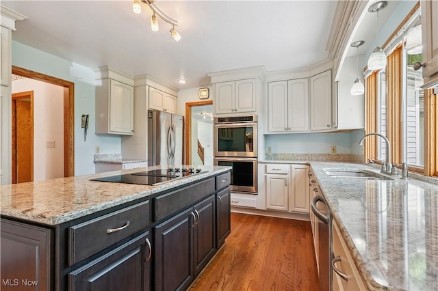 118 Steeplechase Ln, Munroe Falls, OH 44262 - kitchen with stainless steel appliances, white cabinets, wood finished floors, a center island, and light stone countertops