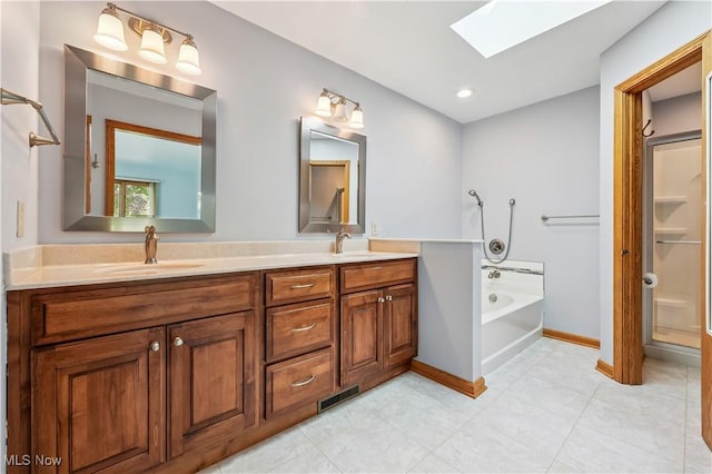 118 Steeplechase Ln, Munroe Falls, OH 44262 - full bath with a skylight, double vanity, a bath, tile patterned flooring, and a shower stall