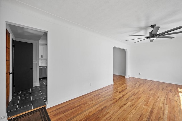 3722 Avalon Rd, Shaker Heights, OH 44120 - empty room with ceiling fan, light wood-style flooring, and arched walkways