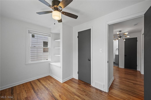 3722 Avalon Rd, Shaker Heights, OH 44120 - unfurnished bedroom with wood finished floors, a chandelier, and a ceiling fan