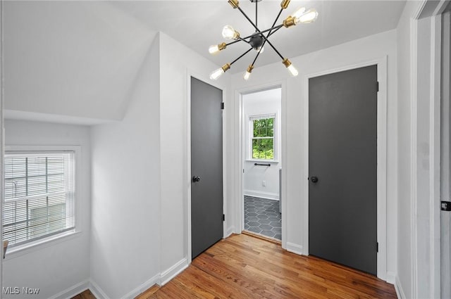 3722 Avalon Rd, Shaker Heights, OH 44120 - hallway featuring a chandelier and light wood-type flooring