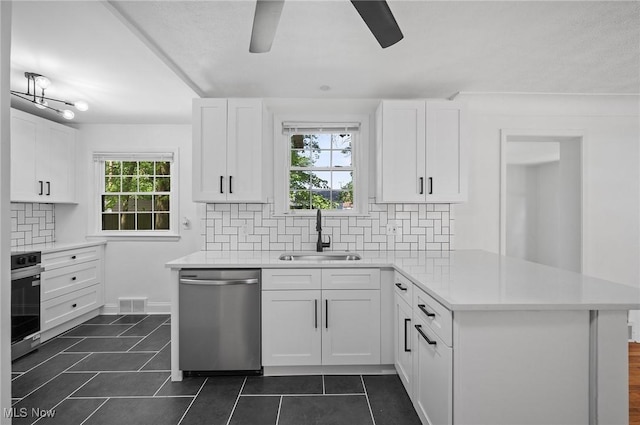 3722 Avalon Rd, Shaker Heights, OH 44120 - kitchen with stainless steel dishwasher, a peninsula, dark tile patterned flooring, and ceiling fan