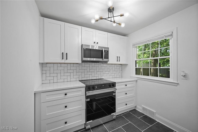 3722 Avalon Rd, Shaker Heights, OH 44120 - kitchen featuring stainless steel microwave, electric range, light countertops, and decorative backsplash