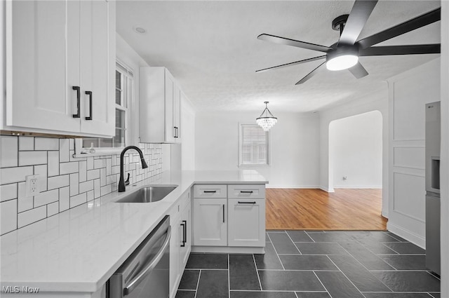 3722 Avalon Rd, Shaker Heights, OH 44120 - kitchen featuring dishwasher, a peninsula, white cabinets, tasteful backsplash, and plenty of natural light