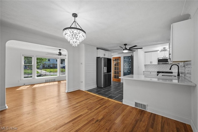3722 Avalon Rd, Shaker Heights, OH 44120 - kitchen with appliances with stainless steel finishes, a ceiling fan, a chandelier, light countertops, and a peninsula
