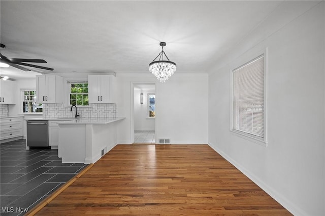 3722 Avalon Rd, Shaker Heights, OH 44120 - kitchen featuring dishwasher, white cabinetry, light countertops, a chandelier, and decorative backsplash