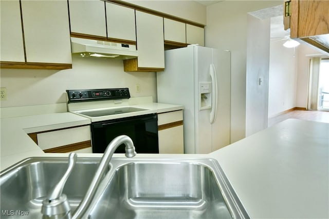 3406 Ivy Hill Cir Unit B, Cortland, OH 44410 - kitchen with electric range oven, white fridge with ice dispenser, under cabinet range hood, and light countertops