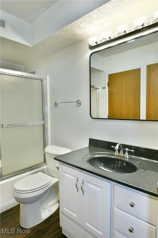 3406 Ivy Hill Cir Unit B, Cortland, OH 44410 - bathroom featuring vanity, wood finished floors, and shower / bath combination with glass door
