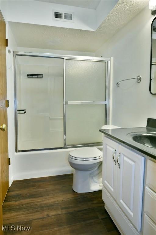 3406 Ivy Hill Cir Unit B, Cortland, OH 44410 - bathroom with vanity, enclosed tub / shower combo, and wood finished floors