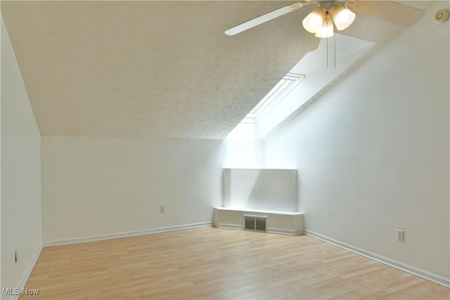 3406 Ivy Hill Cir Unit B, Cortland, OH 44410 - bonus room featuring lofted ceiling, ceiling fan, light wood finished floors, and a textured ceiling