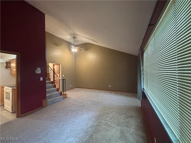 25320 Clubside Dr Unit 6, North Olmsted, OH 44070 - empty room with vaulted ceiling, light carpet, ceiling fan, and stairway