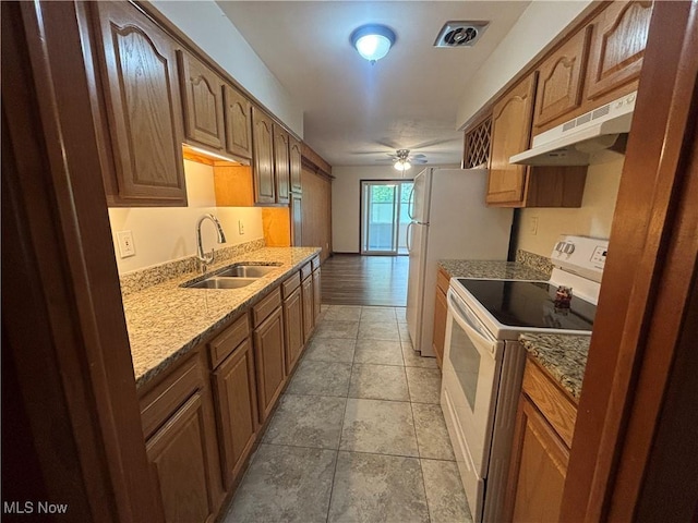 25320 Clubside Dr Unit 6, North Olmsted, OH 44070 - kitchen featuring white range with electric stovetop, under cabinet range hood, a ceiling fan, light stone counters, and brown cabinets