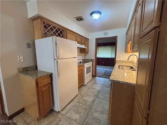 25320 Clubside Dr Unit 6, North Olmsted, OH 44070 - kitchen featuring white appliances, under cabinet range hood, light stone counters, brown cabinetry, and light tile patterned floors