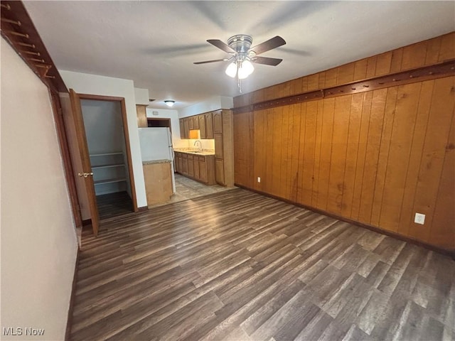 25320 Clubside Dr Unit 6, North Olmsted, OH 44070 - unfurnished living room with wood walls, a ceiling fan, and wood finished floors