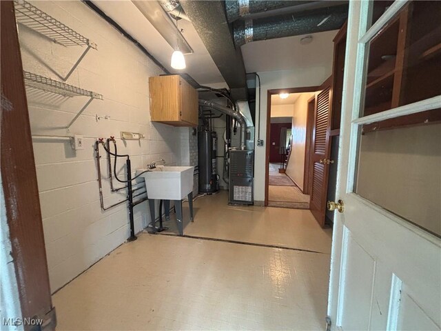 25320 Clubside Dr Unit 6, North Olmsted, OH 44070 - below grade area featuring water heater, heating unit, and concrete block wall