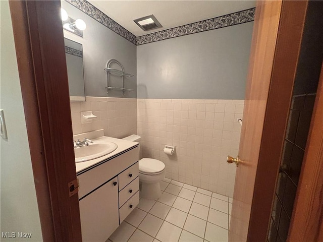 25320 Clubside Dr Unit 6, North Olmsted, OH 44070 - bathroom with tile walls, vanity, tile patterned floors, and a wainscoted wall