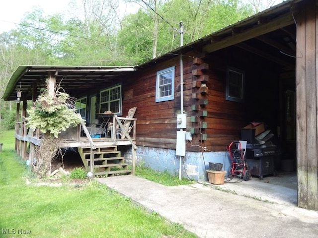 1389 Middle Fork Rd, Millstone, WV 25261 - rear view of property with log exterior and crawl space