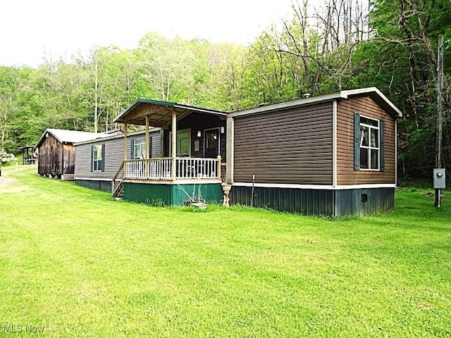 1389 Middle Fork Rd, Millstone, WV 25261 - view of front of home with a front yard, a porch, and a view of trees