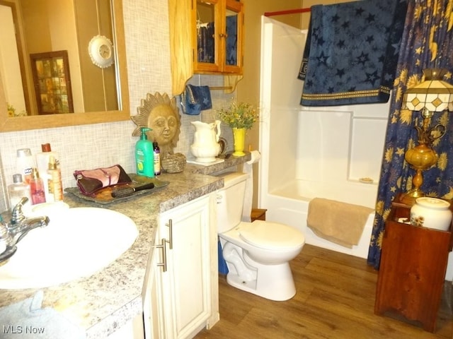 1389 Middle Fork Rd, Millstone, WV 25261 - bathroom featuring wood finished floors, decorative backsplash, vanity, and shower / bath combo