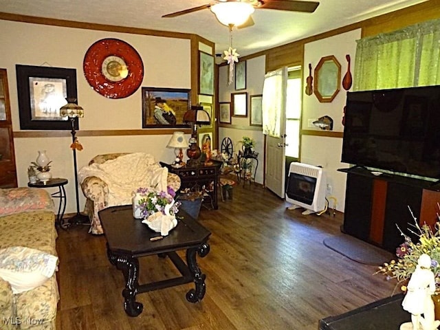 1389 Middle Fork Rd, Millstone, WV 25261 - living room with heating unit, a ceiling fan, wood finished floors, ornamental molding, and a wood stove