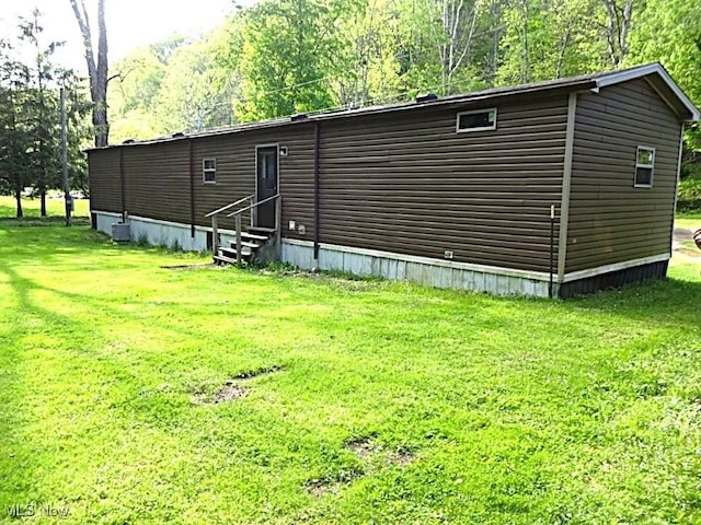 1389 Middle Fork Rd, Millstone, WV 25261 - rear view of house with entry steps and a lawn