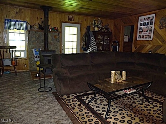 1389 Middle Fork Rd, Millstone, WV 25261 - carpeted living area with wood walls, plenty of natural light, wooden ceiling, and a wood stove