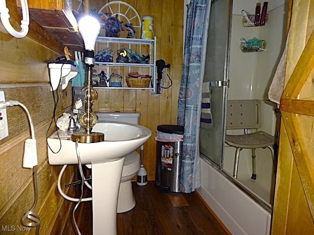 1389 Middle Fork Rd, Millstone, WV 25261 - bathroom featuring wooden walls, wood finished floors, and bath / shower combo with glass door