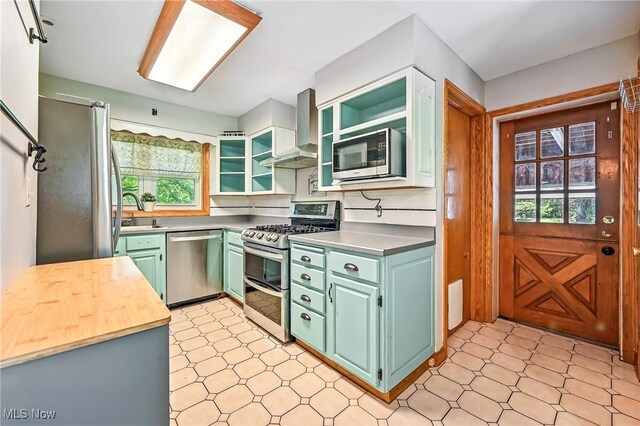 1130 Dairy Ln, East Liverpool, OH 43920 - kitchen with stainless steel appliances, wall chimney range hood, green cabinets, light flooring, and open shelves