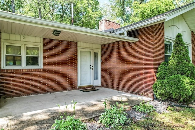 1130 Dairy Ln, East Liverpool, OH 43920 - view of exterior entry featuring a chimney and brick siding