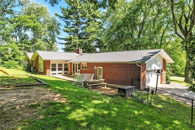 1130 Dairy Ln, East Liverpool, OH 43920 - back of house featuring brick siding, concrete driveway, a garage, and a chimney