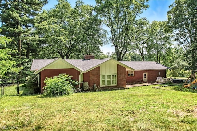 1130 Dairy Ln, East Liverpool, OH 43920 - back of property with a chimney, roof with shingles, brick siding, and view of scattered trees