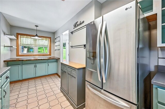 1130 Dairy Ln, East Liverpool, OH 43920 - kitchen with stainless steel fridge with ice dispenser, light floors, open shelves, pendant lighting, and wooden counters