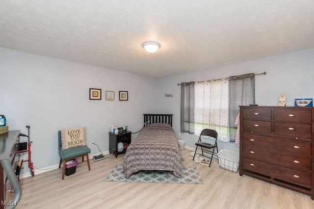 6655 Arbor Way Unit 8, Parma, OH 44134 - bedroom featuring light wood finished floors and a textured ceiling