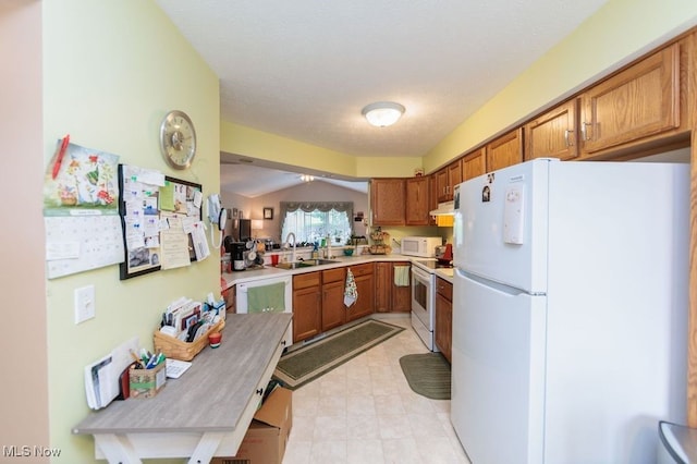 6655 Arbor Way Unit 8, Parma, OH 44134 - kitchen featuring white appliances, brown cabinets, light countertops, under cabinet range hood, and light floors