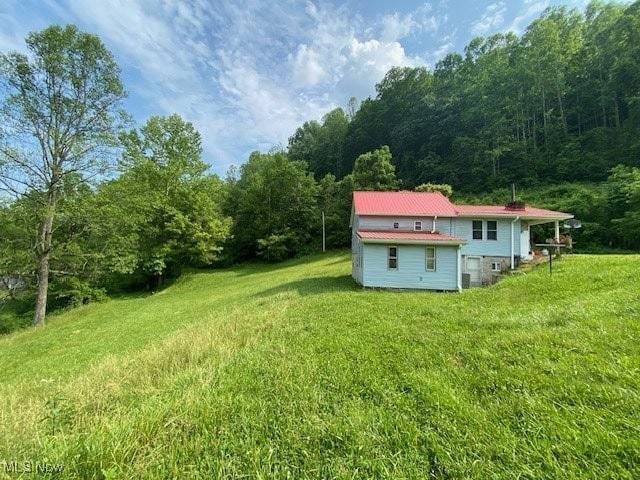 8710 Clay Rd, Left Hand, WV 25251 - view of grassy yard with a view of trees