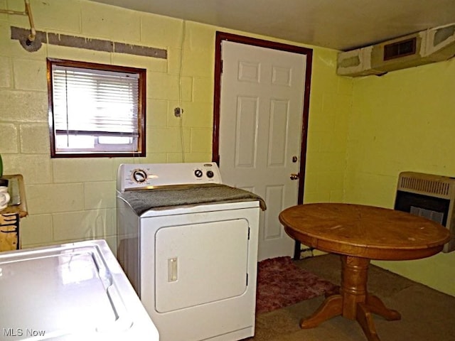 8710 Clay Rd, Left Hand, WV 25251 - washroom featuring washing machine and clothes dryer, concrete block wall, and heating unit