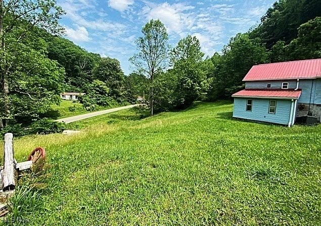 8710 Clay Rd, Left Hand, WV 25251 - view of grassy yard with a wooded view