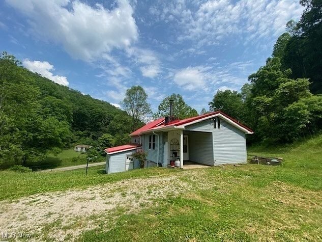 8710 Clay Rd, Left Hand, WV 25251 - back of house featuring an outbuilding