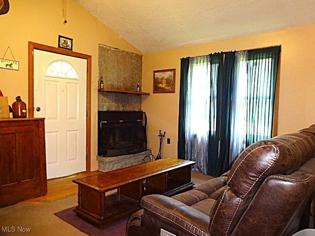 8710 Clay Rd, Left Hand, WV 25251 - living area with lofted ceiling, a stone fireplace, and wood finished floors
