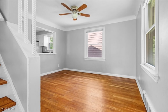 19501 Libby Rd, Maple Heights, OH 44137 - unfurnished room featuring light wood-type flooring, a ceiling fan, and stairway