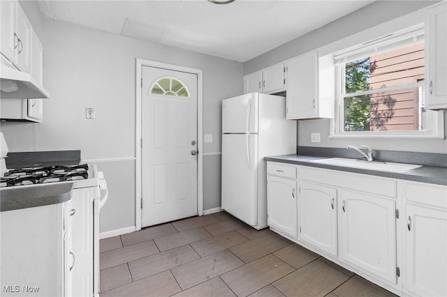 19501 Libby Rd, Maple Heights, OH 44137 - kitchen featuring white appliances, white cabinets, plenty of natural light, and under cabinet range hood