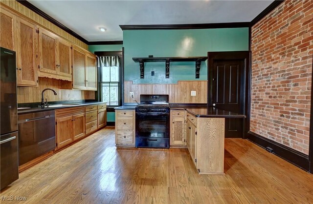 606 N Wooster Ave, Dover, OH 44622 - kitchen with black appliances, crown molding, dark countertops, light wood-style flooring, and brick wall