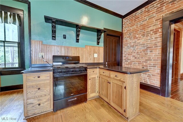 606 N Wooster Ave, Dover, OH 44622 - kitchen with black gas range, ornamental molding, dark countertops, light wood finished floors, and healthy amount of natural light