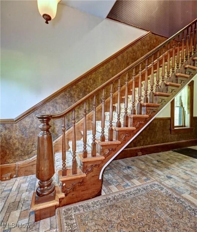 606 N Wooster Ave, Dover, OH 44622 - stairs featuring stone tile floors and inlaid floor details