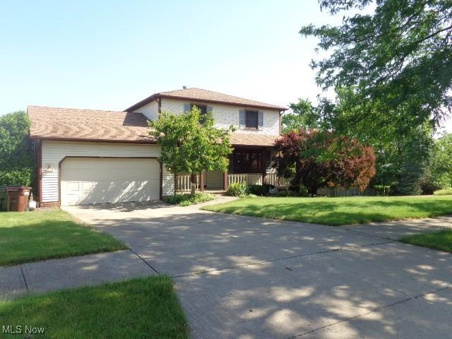 4326 Wood Thrush Dr, Parma, OH 44134 - view of front of property featuring concrete driveway, a garage, and a front lawn