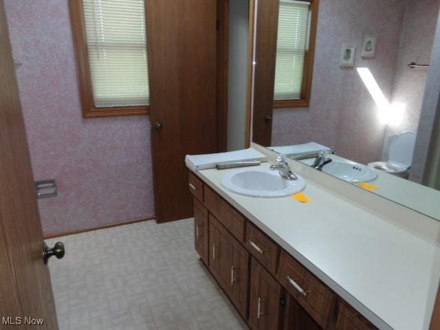 4326 Wood Thrush Dr, Parma, OH 44134 - bathroom featuring tile patterned floors, vanity, and wallpapered walls