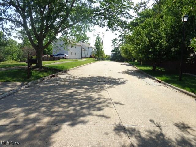 4326 Wood Thrush Dr, Parma, OH 44134 - view of concrete road featuring curbs and street lights