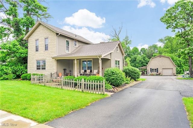 337 Youngstown Kingsville Rd SE, Vienna, OH 44473 - view of front of home featuring a garage, an outdoor structure, covered porch, stone siding, and roof with shingles