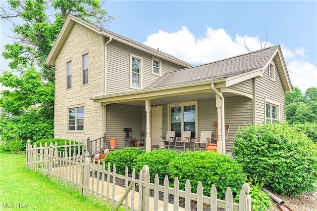 337 Youngstown Kingsville Rd SE, Vienna, OH 44473 - traditional-style house with stone siding, a shingled roof, and covered porch